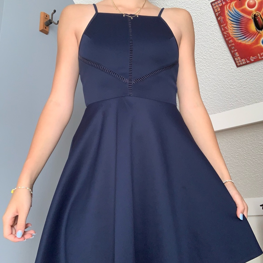Semi-formal, navy blue, mini dress, with adjustable straps, and front details.